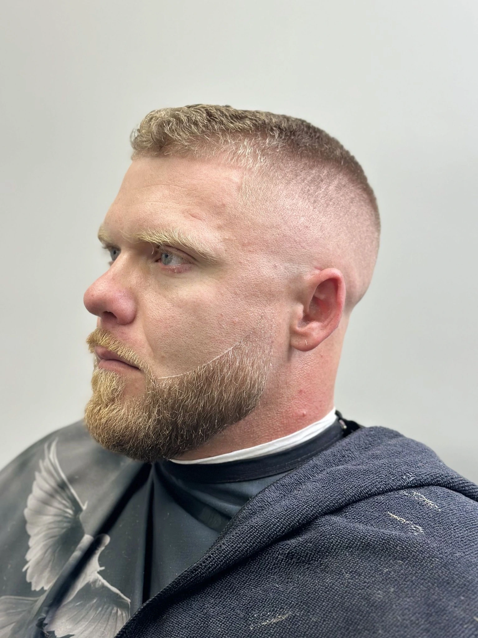 Blond hair skin fade with styled beard at JTZCUTZ